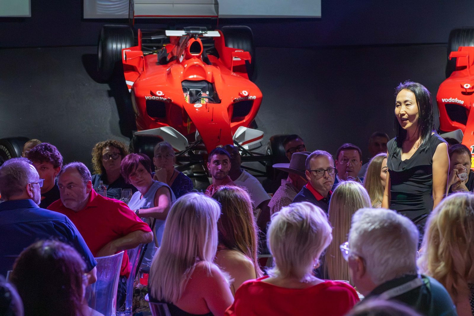 Eri Ishikawa speaking to guests at a Ferrari event